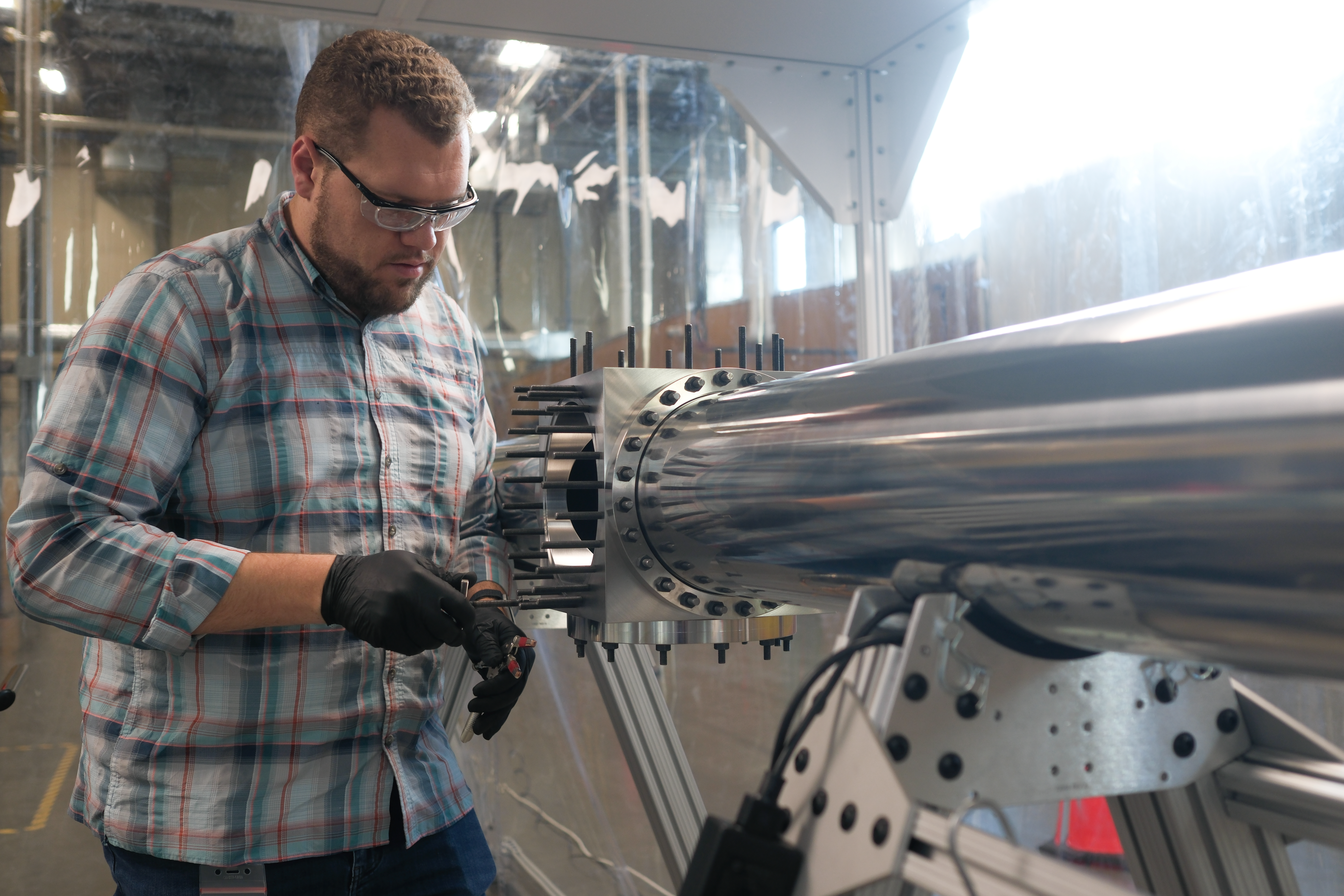 An optical engineer works on a pulse compression cell.