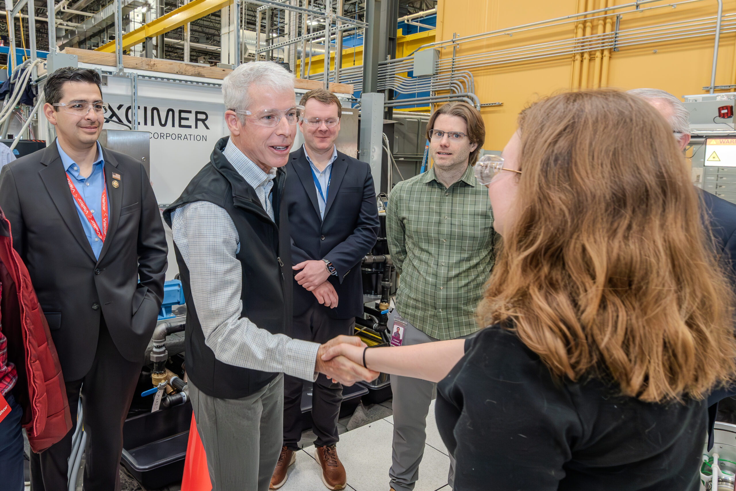 During a technical briefing at Denver-based laser fusion leader Xcimer Energy, U.S. Energy Sec. Chris Wright greets pulsed power engineer Micah LaPointe. Looking on from left are U.S. Rep. Gabe Evans of Colorado; Xcimer Co-founder, President and CTO Alexander Valys; and Xcimer Co-founder and CEO Conner Galloway. Photo by Edward DeCroce
